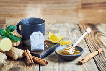 Tea cup served on wooden table. Ginger Tea cup with lemon cinnamon and honey served on wooden table. Hot ginger tea.