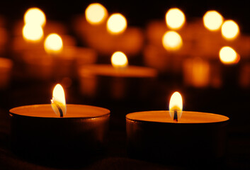 Many burning candles with bokeh light background