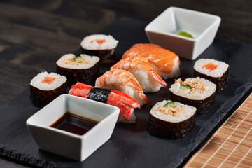 Sushi variety on a black stone