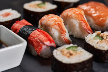 Sushi variety on a black stone