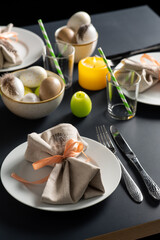 easter, holidays, tradition and object concept - close up of dinner party table serving over black background