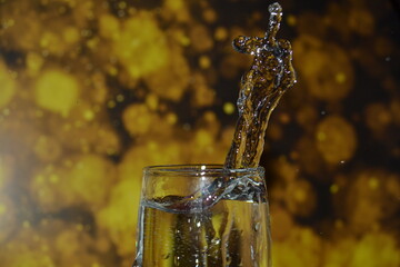 splashes of water on a beautiful yellow black background.