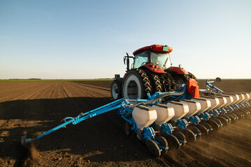 Farmer with tractor seeding