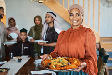 Cooking for my family brings me peace. Shot of a muslim woman holding a plate of food.