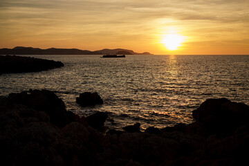 Cala Viola de Ponent, Menorca. September 2021. Magnificent sunset in the Mediterranean Sea. On one of the paradisaical beaches of the island of Menorca.