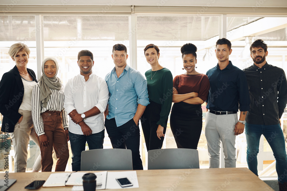 Wall mural were here to help. cropped portrait of a group of business colleagues standing in their office board