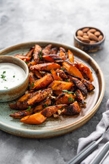 Honey garlic butter roasted carrots on a concrete background. Roasted carrots prepared with garlic butter and sweet honey sauce. Homemade glazed carrots