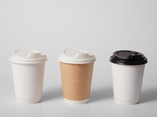 Three takeaway paper cups on white background.