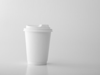 White takeaway paper cup with white plastic lid. .