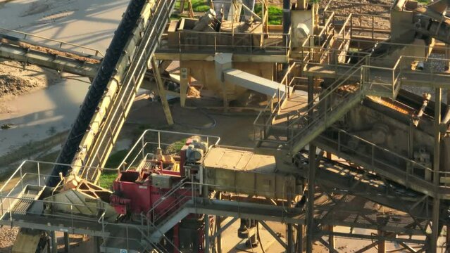 Aerial shot of machines and trucks working in a sand quarry, in France. Those are extracting and  filtering the sand.
