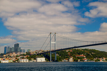 Fototapeta na wymiar Ferries passing by Bosporus with blue sky and clouds. Istanbul Bosporus Bridge on day time
