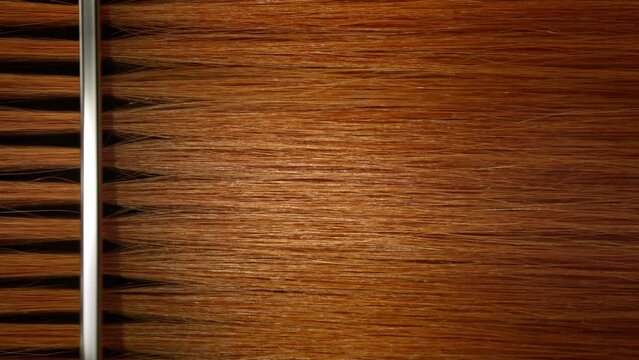 Vertical shot of Silver comb combing ginger hair | Hair dye commercial