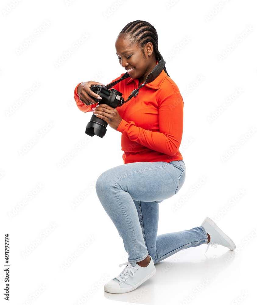 Wall mural people, profession and photography concept - happy smiling woman photographer with digital camera photographing over white background