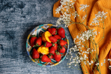 Still life with strawberry. Beautiful fruit close up photo. Sunny summer day. Textured background with copy space. 
