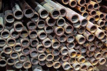 Round steel pipe stacked on top of each other.