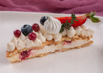 cake in the form of the number eight for the holiday with cream and strawberries rosemary blueberries and marshmallows	