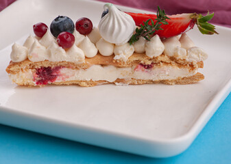 cake in the form of the number eight for the holiday with cream and strawberries rosemary blueberries and marshmallows	