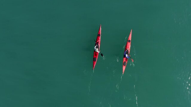 Single seat canoe rowing over a shallow lagoon, Aerial view.