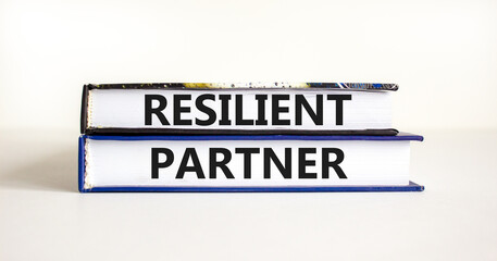 Resilient partner symbol. Concept words Resilient partner on books on a beautiful white table white background. Business resilience and resilient partner concept, copy space.