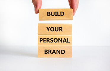 Build your personal brand symbol. Concept words Build your personal brand on wooden blocks. Businessman hand. Beautiful white background. Build your personal brand business concept. Copy space.