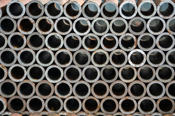Round steel pipe stacked on top of each other.