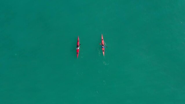 Single seat canoe rowing over a shallow lagoon, Aerial view.