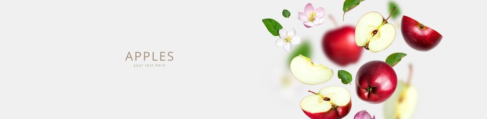 Flying red fresh apples, apple flowers inflorescences green leaves isolated on gray background. Creative concept of food, harvest. Whole ripe apples and half. Sweet summer organic fruit