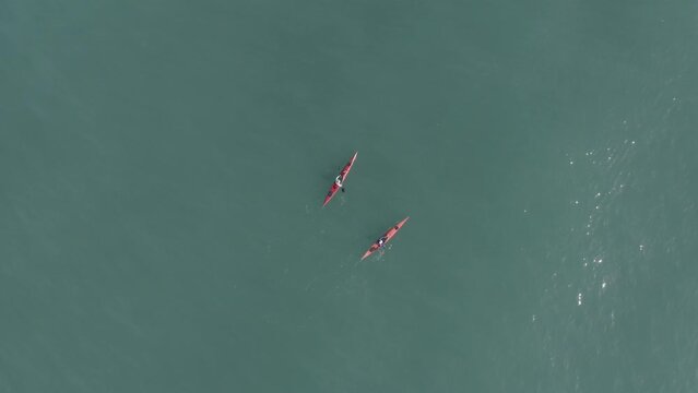 Single seat canoe rowing over a shallow lagoon, Aerial view.
