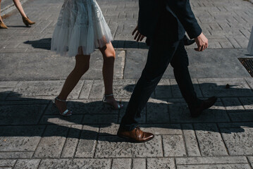 Newlywed romantic wedding couple walking. The bride and groom walk holding hands.