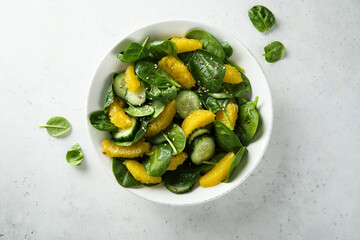 Healthy spinach salad with orange and cucumber