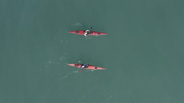 Single seat canoe rowing over a shallow lagoon, Aerial view.