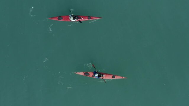 Single seat canoe rowing over a shallow lagoon, Aerial view.