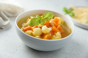 Homemade cauliflower soup with fresh basil