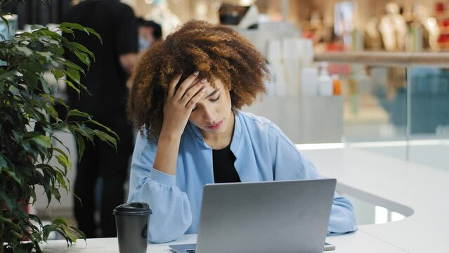 African stressful business woman with laptop sad upset freelancer girl student frustrated shocked reading bad news online lost failed test exam results reads terrible email upset problem notification