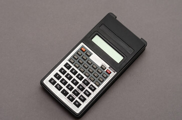Scientific calculator against gray background.