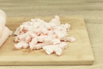 Fototapeta na wymiar Fresh and raw lard finely chopped, meat on a cutting board