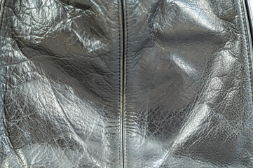 Black leather texture. Glossy leather surface with a vertical line. Natural background