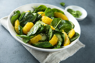 Healthy spinach salad with orange and cucumber