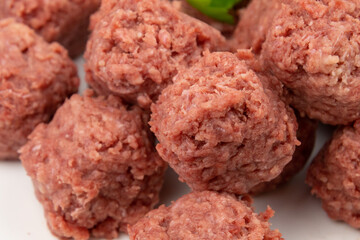 close up of raw beef dumpling in white plate