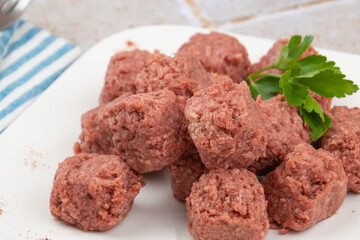 raw beef dumpling in a white plate