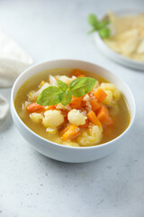 Homemade cauliflower soup with fresh basil