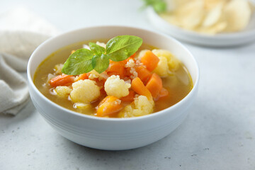 Homemade cauliflower soup with fresh basil