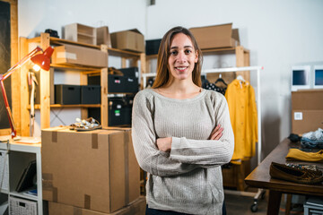 Portrait of a business woman arms folded, self-confident - Young female sells products online - Millennial uses websites to market second hand clothing that does not use - Start up concept