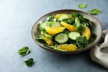 Healthy spinach salad with orange and cucumber
