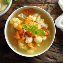Homemade cauliflower soup with fresh basil