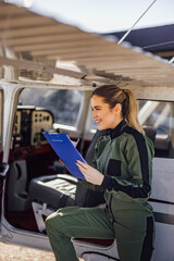 Confident Caucasian female pilot, preparing to fly the plane on