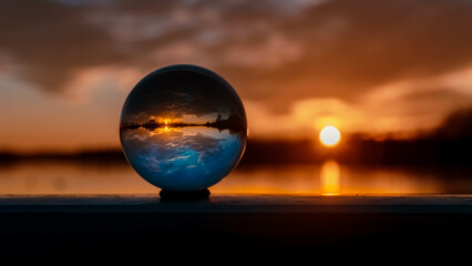 Crystal ball sunset shot with reflections at Plattling, Isar, Bavaria, Germany