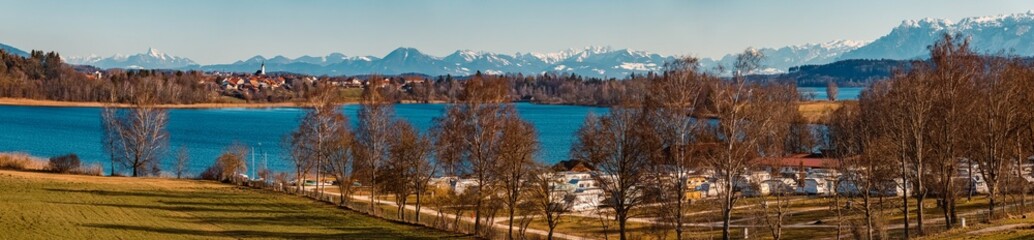 High resolution winter panorama with the austrian alps in the background at the famous Waginger See lake, Bavaria, Germany - obrazy, fototapety, plakaty