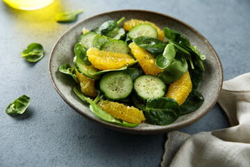 Healthy spinach salad with orange and cucumber
