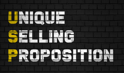 Unique selling proposition (USP) concept,business abbreviations on black wall 